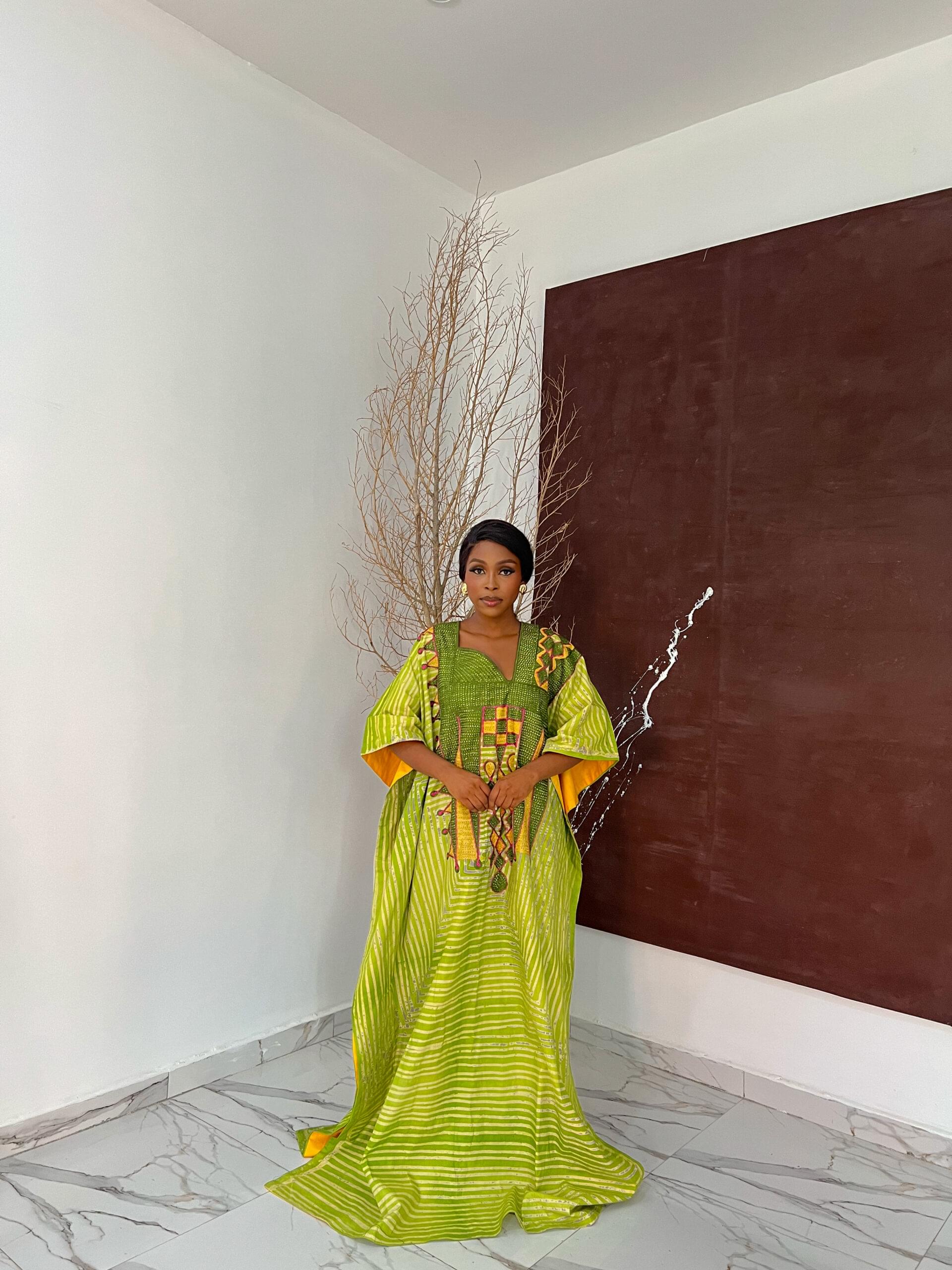 DABIRA BUBU Handmade Adire Bubu for Sale showing a picture of a woman wearing Dabira Bubu dress made by Tailored by Adunni